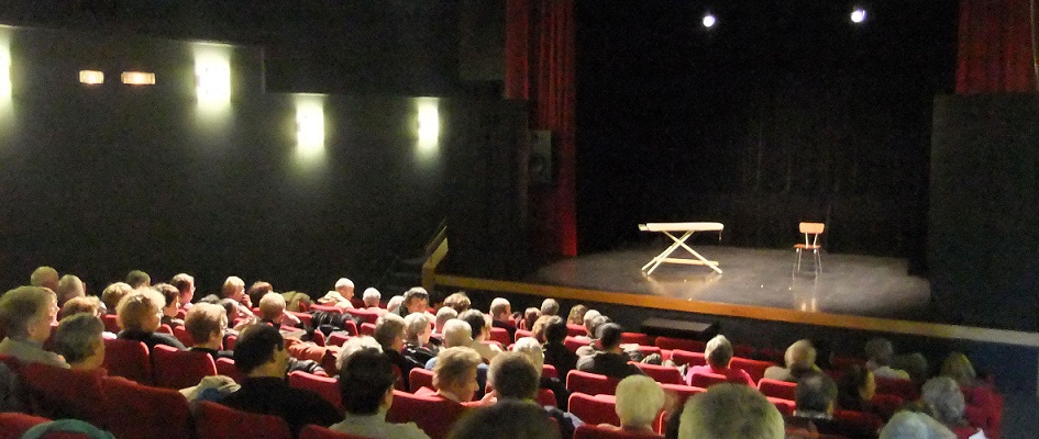 Salle de spectacle de Vibraye, Le quai des arts. Photo prise avant
                  la représentation, le public s'installe. On voit au fond la scène de Cœur
                  de braco avec la planche à repasser et une chaise en formica.