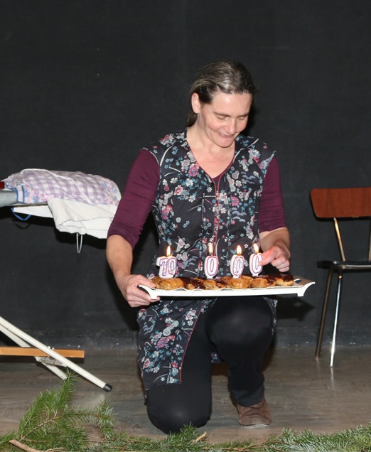 Véronique Blot sur scène en costume de Bernadette la braconnière
                    	solognote. Elle est acroupie et sur son genoux est posé un plat
                    	avec des gâteaux et des bougies représentant 10000. On fête le dix
                    	millième spectateur à Pruniers-en-Sologne dans le Loir-et-Cher.